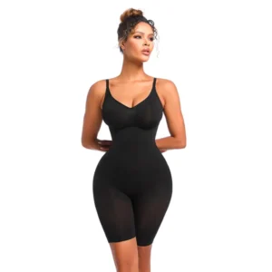 Black woman posing and wearing a black mid-thigh bodysuit over a white background