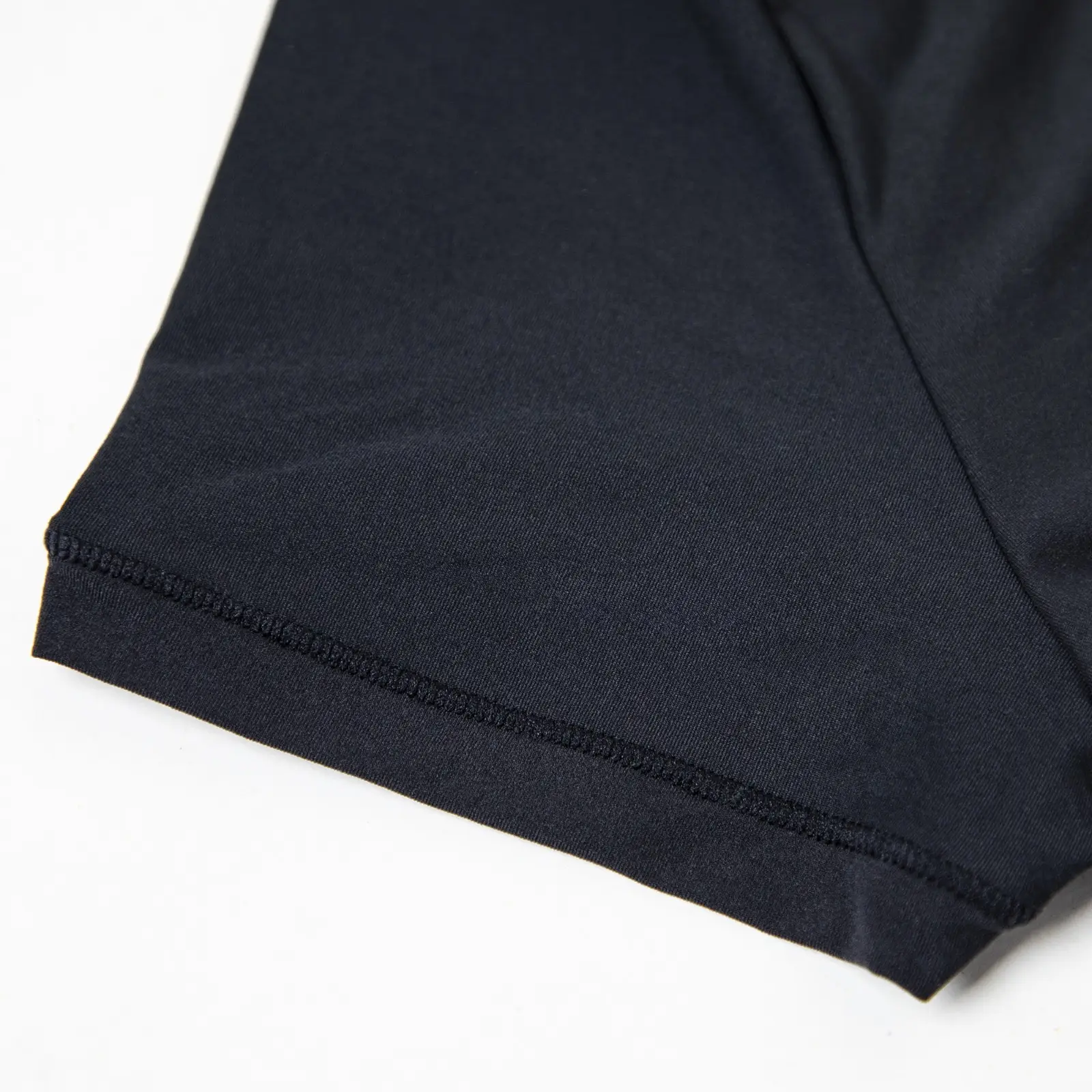 CALIFLO Casual Chic T-shirt Crew Neck Bodysuit black sleeve close up Close-up of black t-shirt bodysuit sleeve over white background.