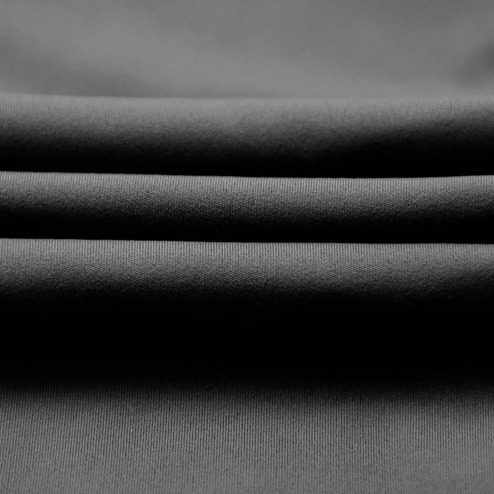 CALIFLO High compression activewear long sleeve low cut bodysuit black fabric close up 2 Close-up of black fabric folded