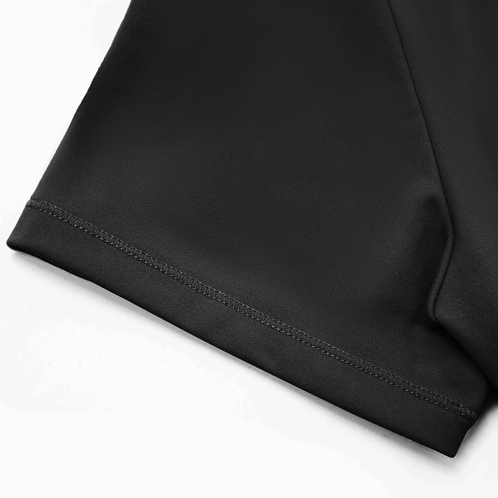 CALIFLO High compression activewear t-shirt bodysuit black sleeve close up Close-up of black t-shirt bodysuit sleeve over a white background