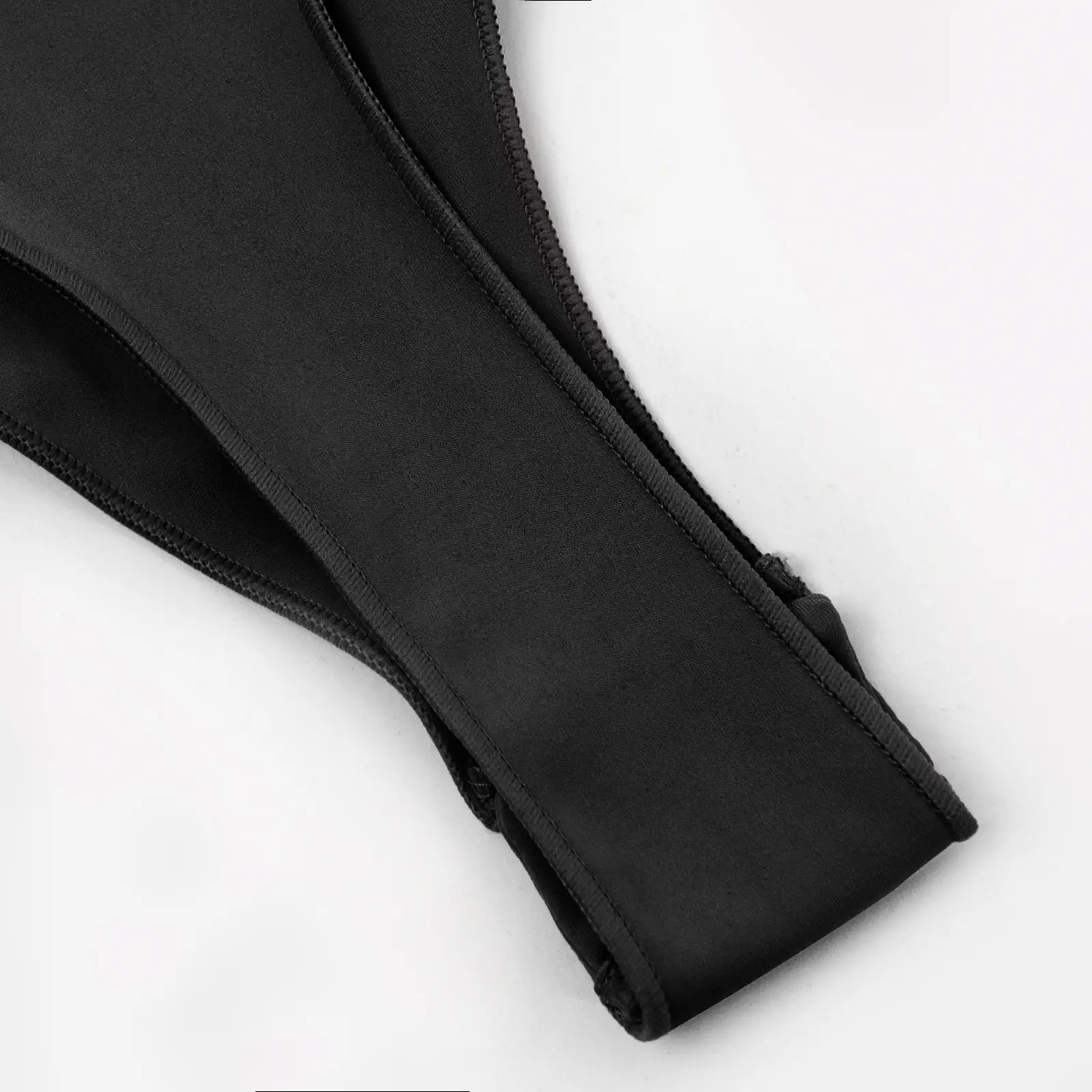 CALIFLO High compression activewear t-shirt bodysuit black thong close up Close-up of black bodysuit thong snap-on closure