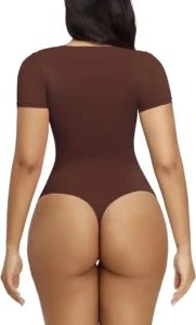 Woman facing backside wearing a brown t-shirt bodysuit over a white background