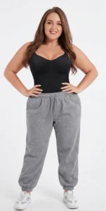 Model wearing a CALIFLO's Classic Body Shaper Bodysuit Woman wearing califlo classic body shaper thong bodysuit with sweatpants