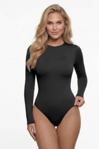 Model wearing a CALIFLO's Snatched Activewear Bodysuit Beth wearing CALIFLO Snatched Activewear Long Sleeve Crew Cut Bodysuit in Black