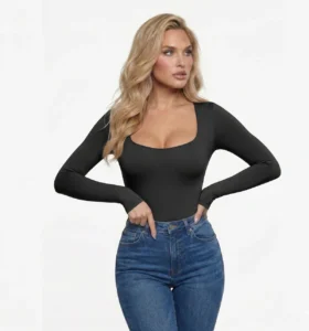 Woman_wearing_black_snatched_activewear_long_sleeve_low_cut_bodysuit._blue_jeans